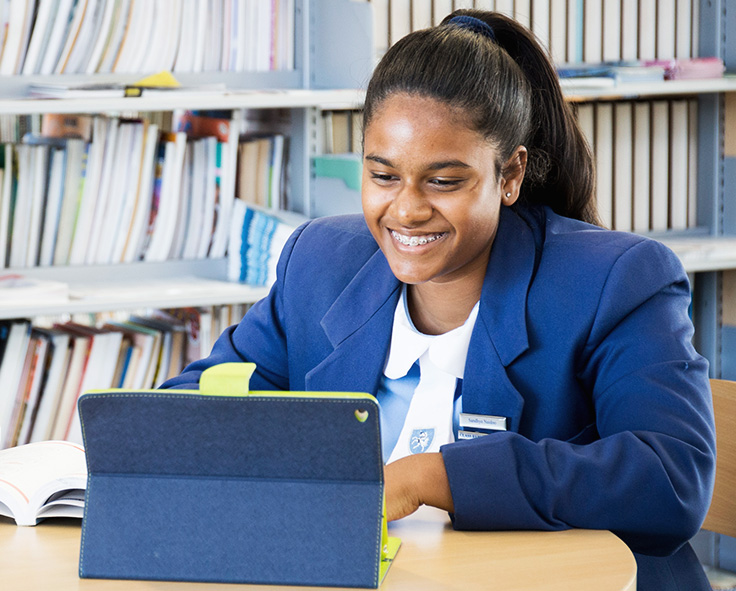snapplify_cloud_services_pay_paragraph_image_2 - snapplify cloud services A teenager in at the library in school uniform, accessing her school work using Snapplify on a tablet device